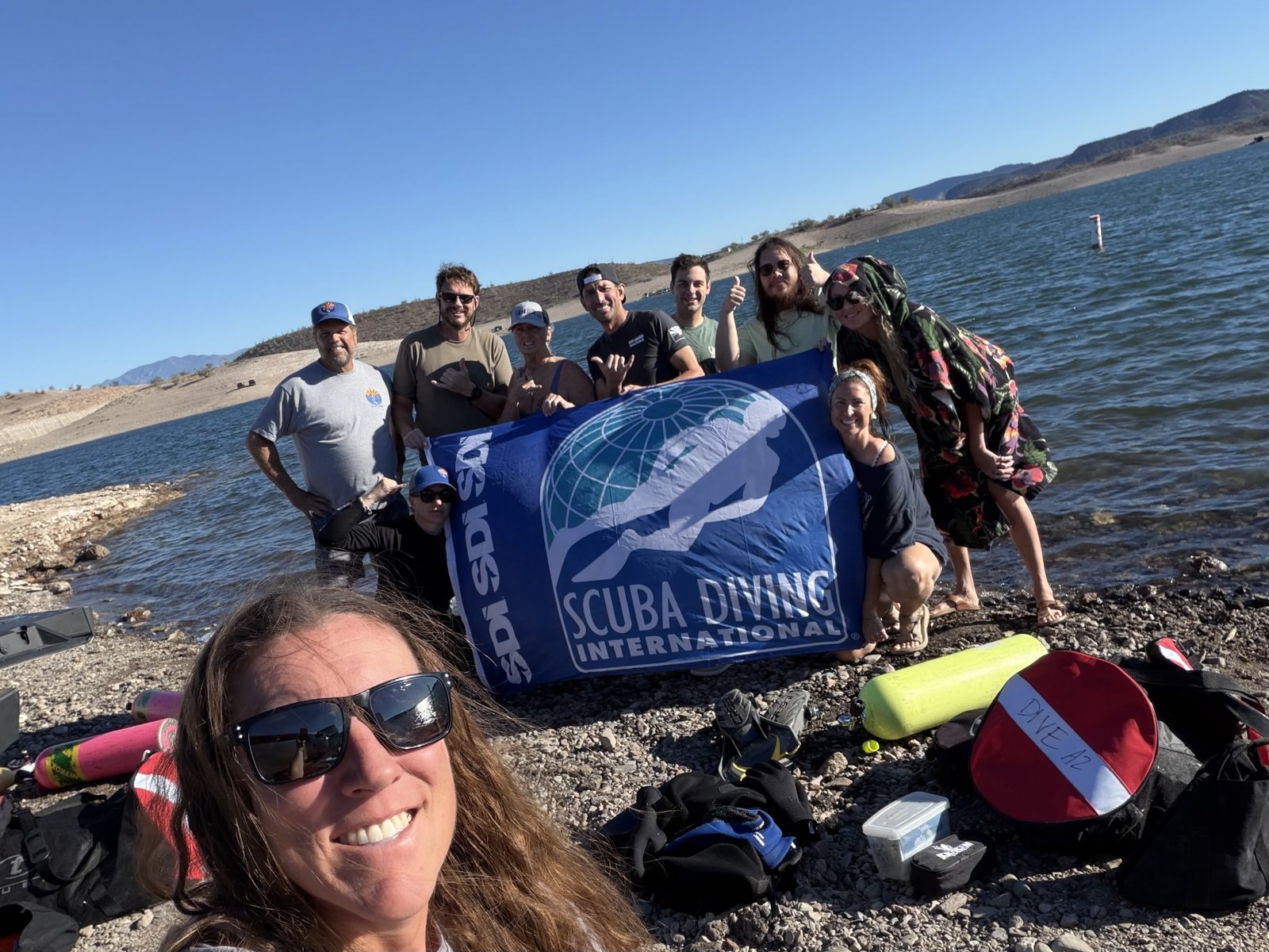 Dive Arizona group at the lake holding the SDI flag